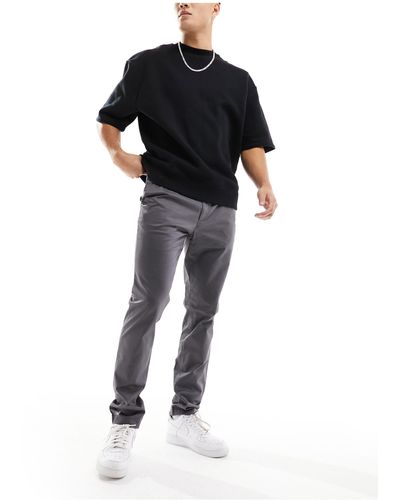 Calvin Klein – elastische satin-chinohose mit schmalem schnitt - Schwarz
