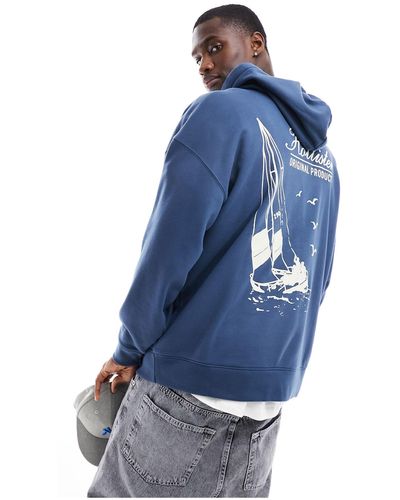 Hollister Sudadera azul extragrande con capucha y estampado en la espalda