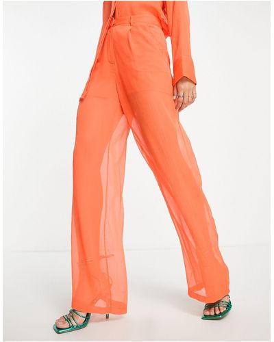 NA-KD Pantaloni con fondo ampio arancioni trasparenti - Arancione
