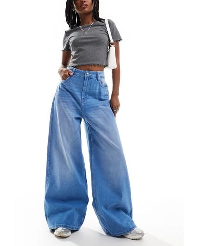 Bershka Jeans chiaro slavato super ampi - Blu