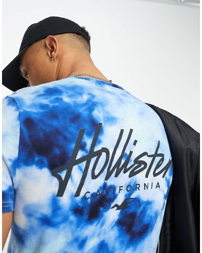 Hollister Camiseta larga azul con lavado ácido y logo en el pecho y la espalda