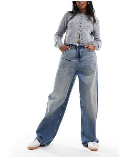Bershka Jeans a vita alta ampi medio lavaggio effetto sporco - Blu