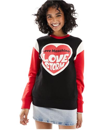 Love Moschino – es sweatshirt mit blockfarbendesign, logo und rundhalsausschnitt - Rot
