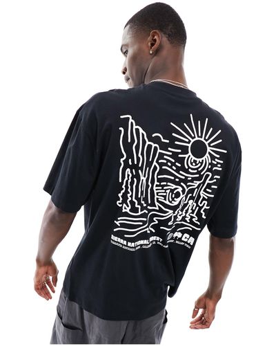 ASOS T-shirt oversize nera con stampa di paesaggio sulla schiena - Nero