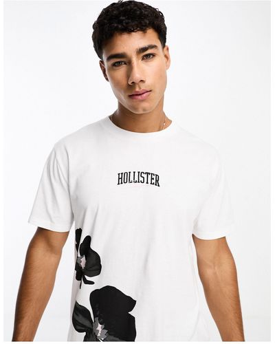 Hollister T-shirt bianca con stampa a fiori e logo centrale - Bianco