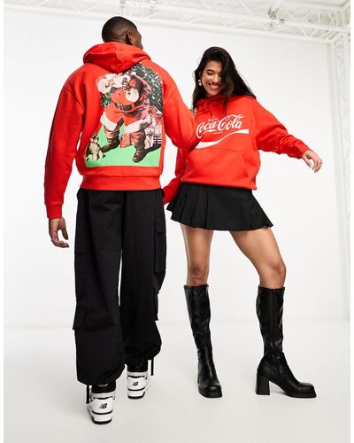 ASOS Sudadera roja extragrande unisex con capucha y estampado navideño con licencia - Rojo