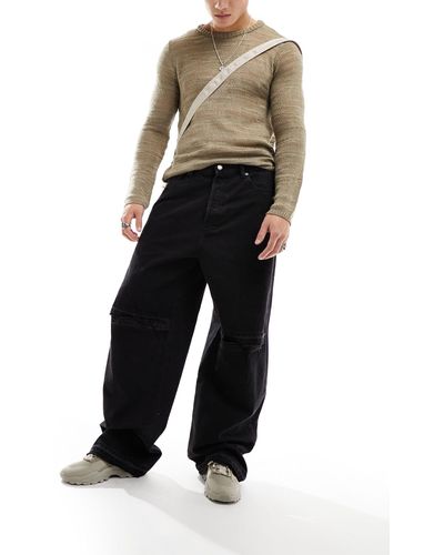 Weekday Astro - jeans larghi a fondo ampio neri con strappo sul ginocchio e dettagli invecchiati - Nero