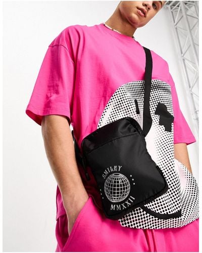ASOS Smiley Collab Cross Body Flight Bag With Metallic Logo - Pink