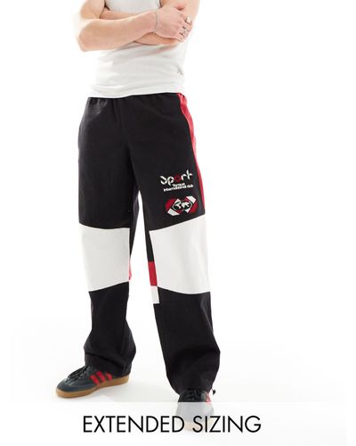 ASOS Pantaloni joggers stile motocross a fondo ampio neri - Bianco