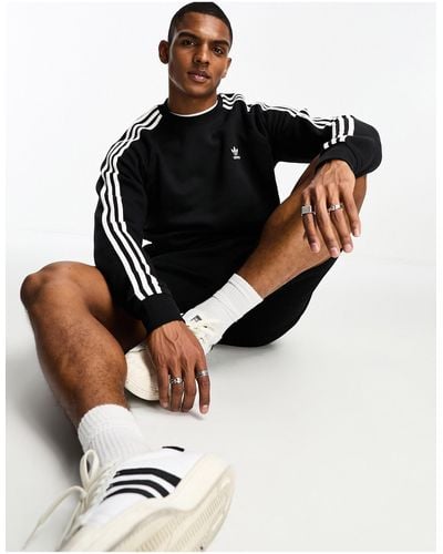 adidas Originals – adicolor – es sweatshirt mit drei streifen - Schwarz