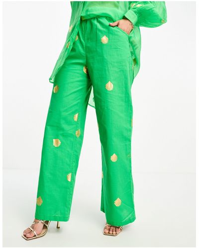 Never Fully Dressed Pantaloni a fondo ampio verdi con conchiglie metallizzate - Verde