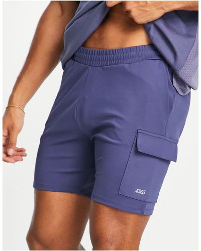 ASOS 4505 Pantalones cortos deportivos ajustados con bolsillos cargo - Azul