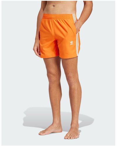 adidas Originals Adicolor - pantaloncini da bagno arancioni con 3 strisce - Arancione