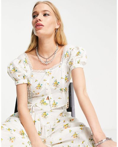 Reclaimed (vintage) Top a corsetto con stampa a fiori e maniche a sbuffo - Bianco
