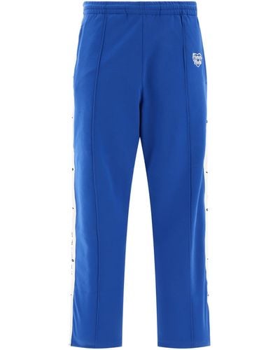 Human Made Pantalon de piste fabriqué humain avec des bandes de logo - Bleu