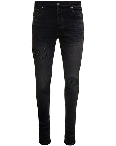 Amiri Skinny Jeans With Crystal Embellished Logo And Used Effect In Stretch Cotton Denim - Black