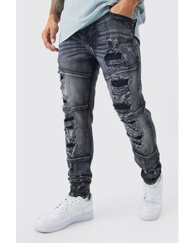 BoohooMAN Skinny Stretch All Over Rip & Repair Jeans - Blue