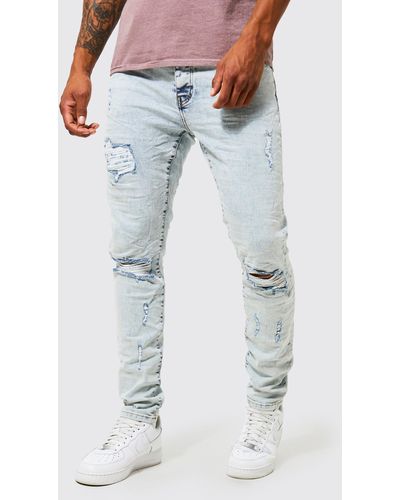 BoohooMAN Skinny Stretch Ripped Knee Crinkle Jeans - Blue