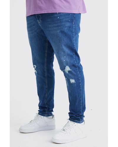 BoohooMAN Plus Skinny Stretch Jeans mit Farbspritzern und Riss am Knie - Blau