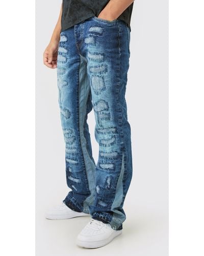 BoohooMAN Slim Flare Rigid All Over Rip & Repaired Jeans In Indigo - Blue