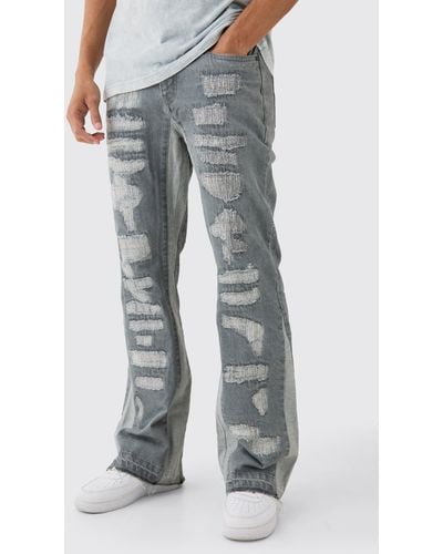 BoohooMAN Slim Flare Rigid All Over Rip & Repaired Jeans In Antique Grey