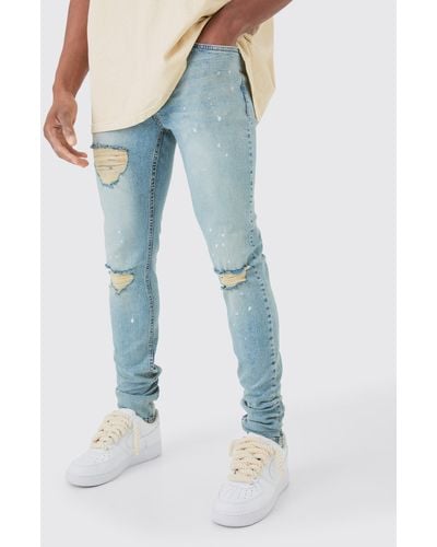 BoohooMAN Skinny Stretch Stacked Ripped Paint Splatter Jeans In Ice Blue