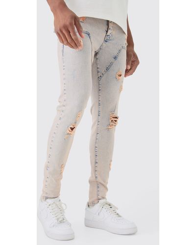 BoohooMAN Skinny Stretch Ripped Carpenter Jeans In Pink Tint