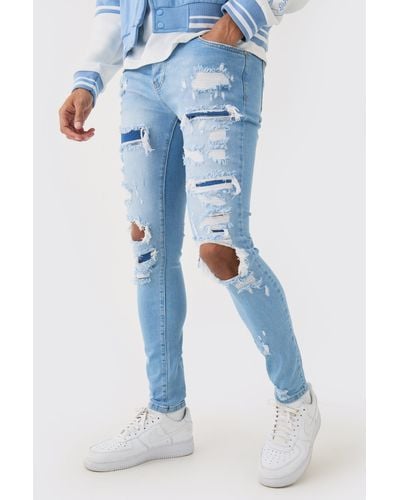 BoohooMAN Skinny Stretch All Over Rip Bleached Denim Jean In Light Blue