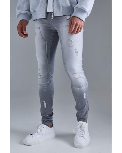 BoohooMAN Skinny Stretch Stacked Ripped Carpenter Zip Hem Jeans In Grey - Blau