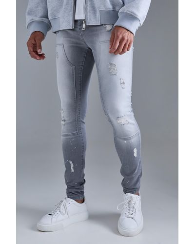 BoohooMAN Skinny Stretch Stacked Ripped Carpenter Zip Hem Jeans In Grey - Blue