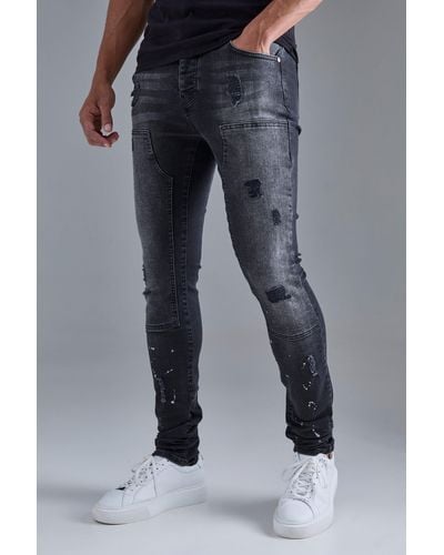 BoohooMAN Skinny Stretch Stacked Ripped Carpenter Zip Hem Jeans In Black - Blue