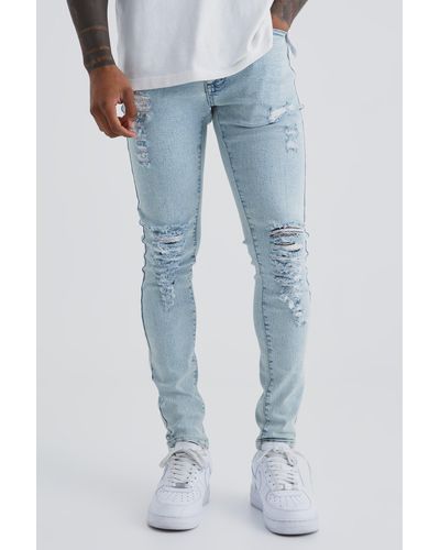 BoohooMAN Super Skinny Jeans With All Over Rips - Blue