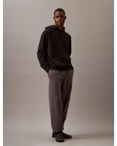 Calvin Klein Embossed Monogram Logo Fleece Sweatpants - Brown