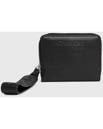 Calvin Klein RFID-Portemonnaie mit Rundum-Reißverschluss und Handgelenkriemen - Schwarz