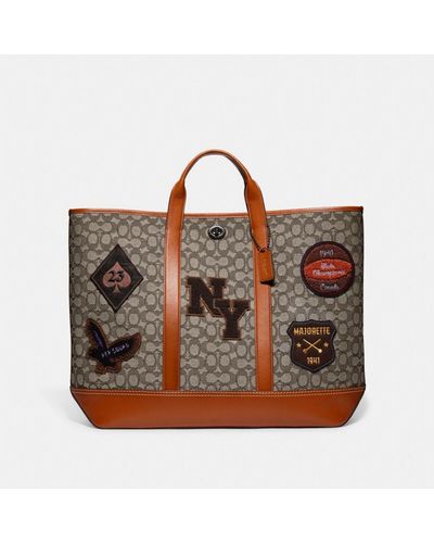 COACH Toby Turnlock Tote In Signature Textile Jacquard With Varsity Patches - Brown