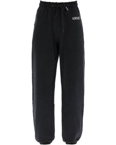 Versace Distressed jogger Pants With Logo Embroidery - Black