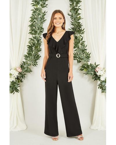 Mela Black Jumpsuit With Gold Buckle And Frill Detail