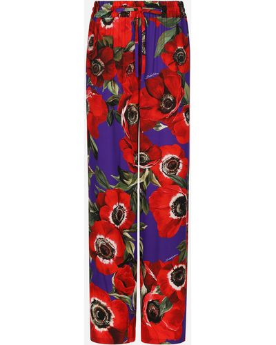 Dolce & Gabbana Pantalone flare in charmeuse stampa fiore anemone - Rosso