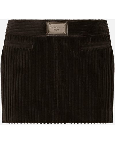 Dolce & Gabbana Mini-jupe en velours côtelé avec plaquette à logo - Noir