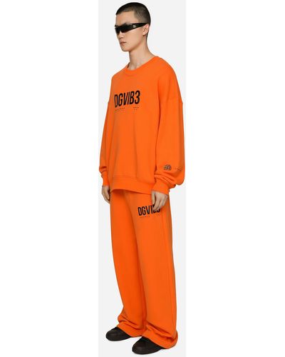 Dolce & Gabbana Pantalón de chándal de punto con estampado DG VIB3 y logotipo - Naranja