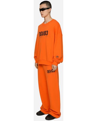 Dolce & Gabbana Pantalón de chándal de punto con estampado DG VIB3 y logotipo - Naranja