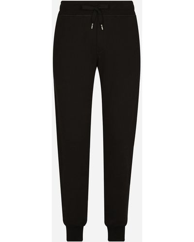 Dolce & Gabbana Pantalón de chándal en punto con placa con logotipo - Negro