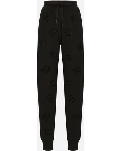Dolce & Gabbana Pantalon de jogging en jersey avec broderie ajourée logo DG - Noir