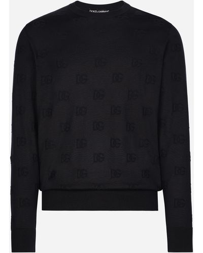 Dolce & Gabbana Pull ras de cou en soie avec DG en intarsia all-over - Noir