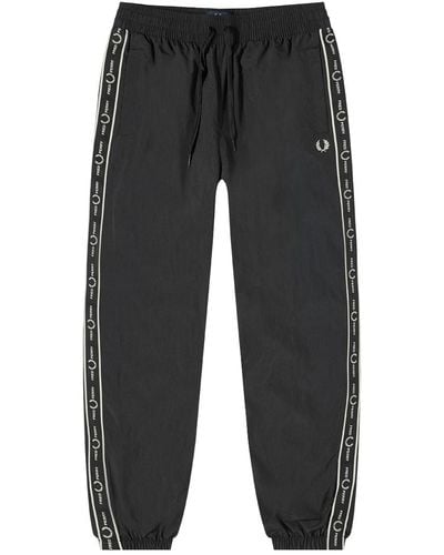 Fred Perry taped track pants in black  ASOS
