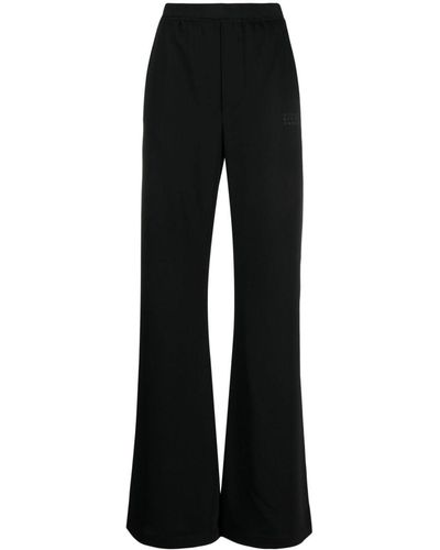 MM6 by Maison Martin Margiela Pantalones acampanados con logo estampado - Negro