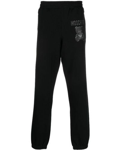 Moschino Pantalon de jogging en coton biologique à logo imprimé - Noir