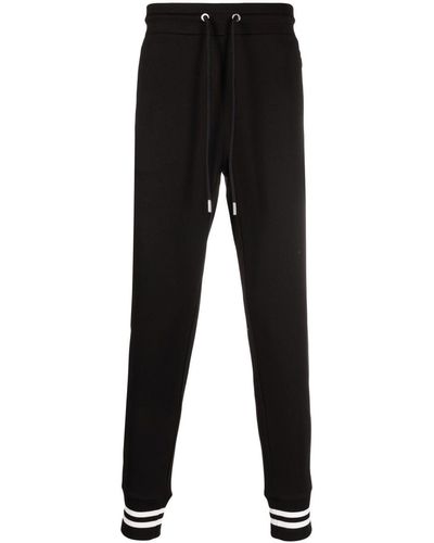 Moncler Pantalon de jogging fuselé à patch logo - Noir