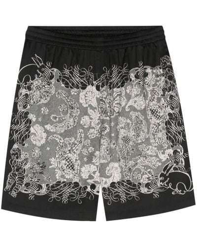 Acne Studios Pantalones cortos de chándal con estampado floral - Negro