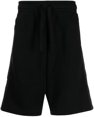 Palm Angels Pantalones cortos de chándal con franja del logo - Negro